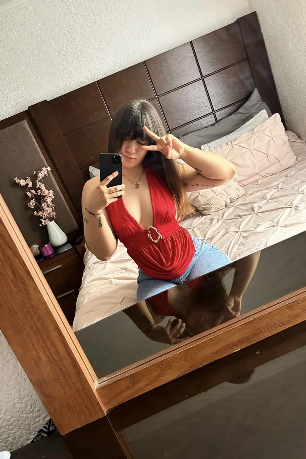 Ara smiling and taking a mirror selfie