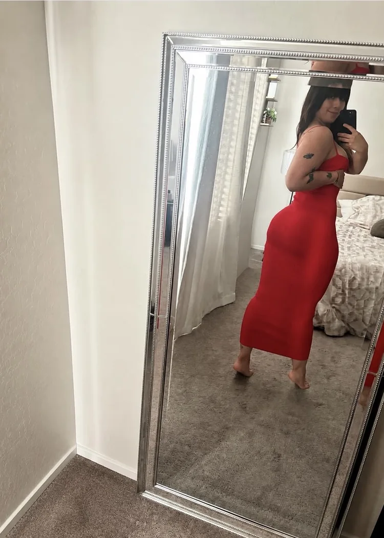 Ara wearing a red dress